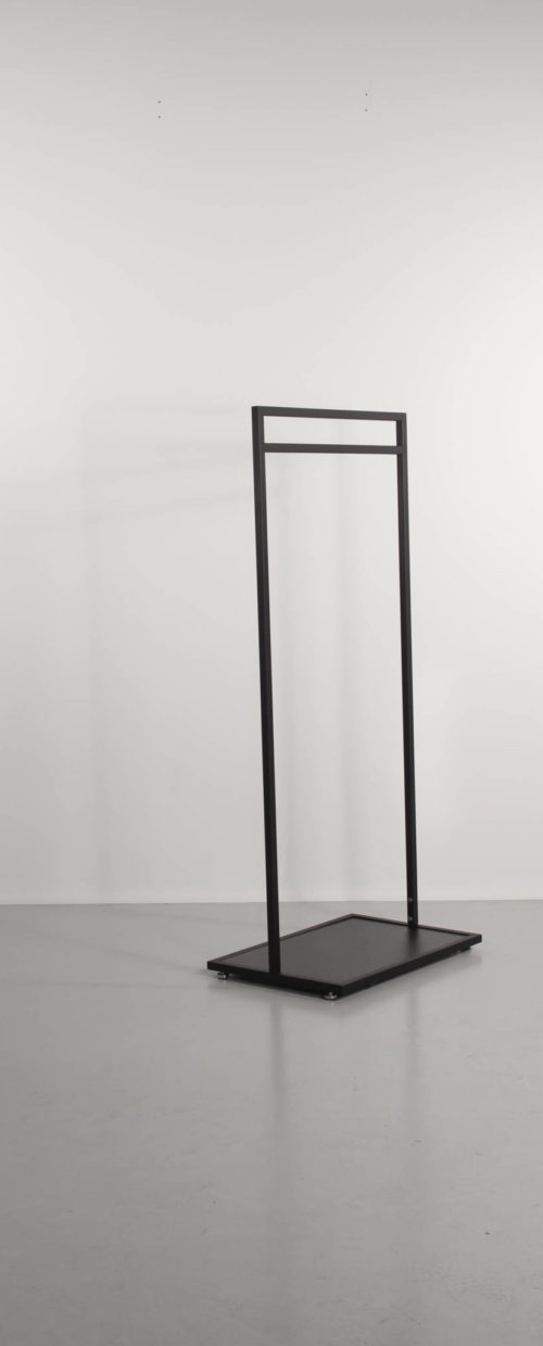 black clothes rack with black base plate. Exhibition stand, the clothing store or at home